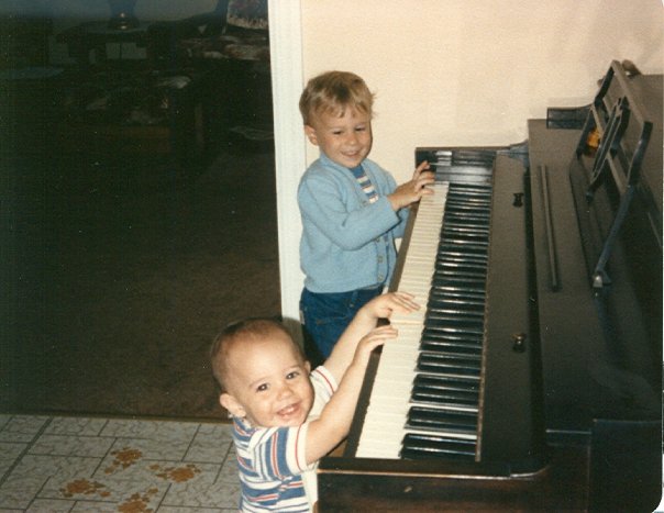 carrozzo brothers playing on piano as toddlers